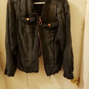 Distressed denim jean jacket with frayed edges